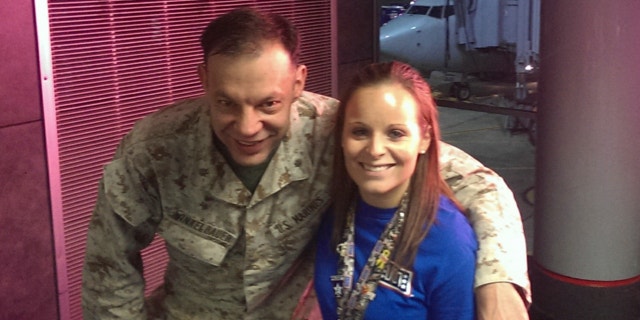 Nov. 4, 2013: Lindsy Wadas, director of the USO Center at Chicago's O'Hare International Airport, is shown with U.S. Marine Maj. Matthew Winkelbauer, left, after he and 13 other Marines arrived in Chicago before the final leg of their trip home to San Diego after a tour in Afghanistan.