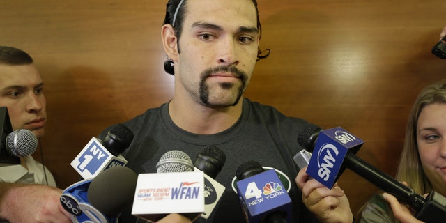 New York Jets quarterback Mark Sanchez talks to reporters after an NFL football practice in Florham Park, N.J., Monday, Aug. 19, 2013. (AP Photo/Seth Wenig)