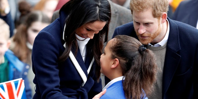 Markle and Prince Harry greet fans in Birmingham, England, on International Women's Day.