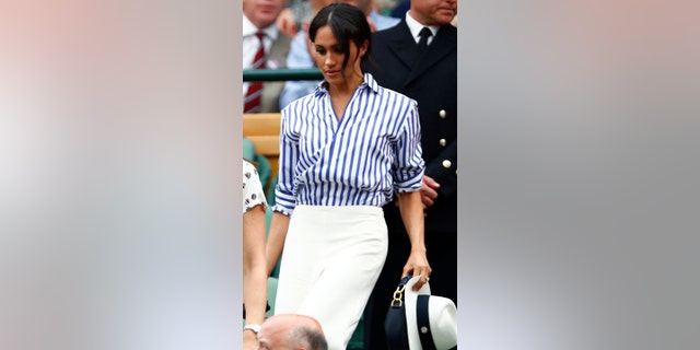 Markle was snapped toting her hat while entering the royal box at Wimbledon.