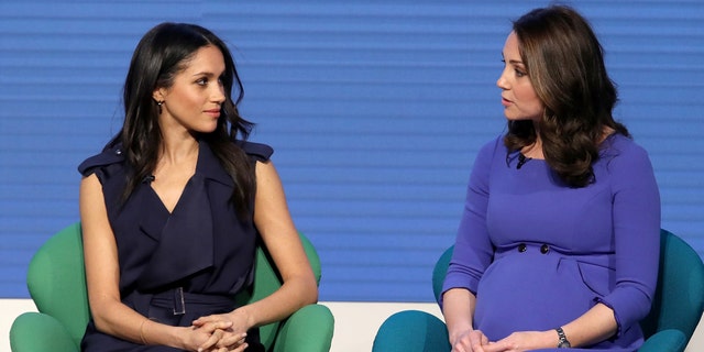 Meghan Markle and Kate share words during an event