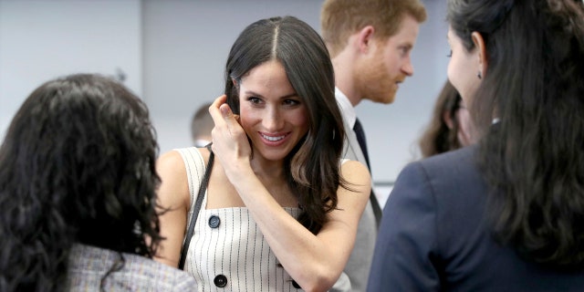 Markle speaks with Commonwealth forum delegates during royal event.