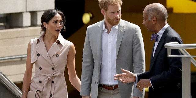 Britain's Prince Harry centre and his wife Meghan the Duchess of Sussex talk with the Lord-Lieutenant of Greater London, Sir Kenneth Olisa as they arrive for the launch of the Nelson Mandela Centenary Exhibition, marking the 100th anniversary of anti-apartheid leader's birth, at the Queen Elizabeth Hall in London, Tuesday, July 17, 2018. (AP Photo/Matt Dunham)