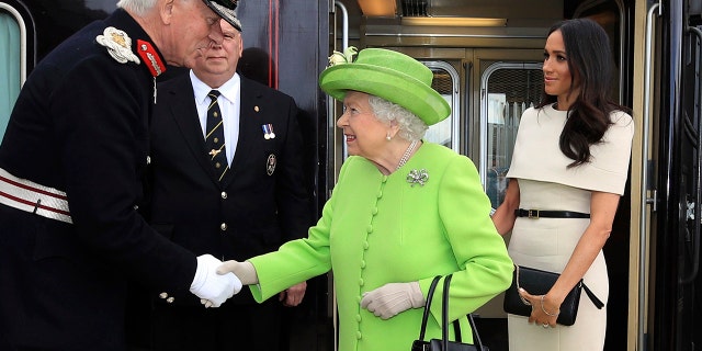 Queen Elizabeth and Meghan, the Duchess of Sussex arrive by Royal Train at Runcorn Station, north west England, Thursday June 14, 2018.
