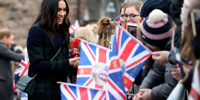 Markle greeting fans outside of Edinburgh Castle in Scotland.