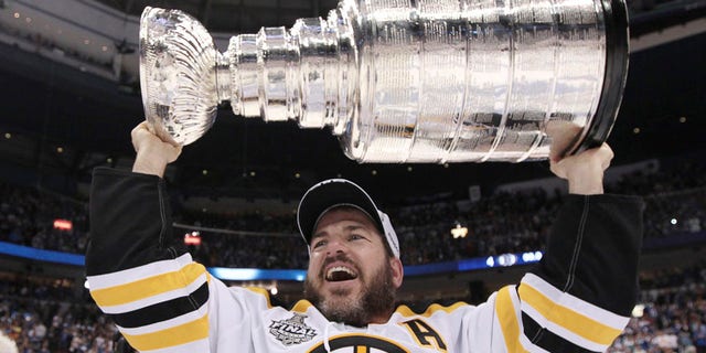 Mark Recchi of the Boston Bruins hoists the Stanley Cup following his team's 4-0 win over the Vancouver Canucks in Game 7 of the Stanley Cup Final.