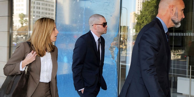 Former "Glee" actor Mark Salling, center, arrives at federal court in Los Angeles on Monday, Dec. 18, 2017. Salling has pleaded guilty to possession of child pornography. (AP Photo/Reed Saxon)