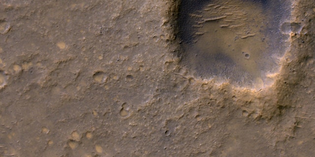 Caption:Near the lower left corner of this view is the three-petal lander platform (circled) that NASA's Mars Exploration Rover Spirit drove off in January 2004.