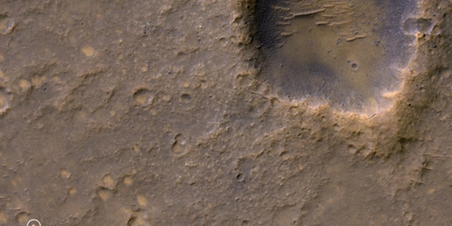Caption:
Near the lower left corner of this view is the three-petal lander platform (circled) that NASA's Mars Exploration Rover Spirit drove off in January 2004.
