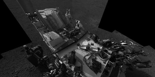 This high-res mosaic of 20 images is the first clear self-portrait of NASA's Mars rover Curiosity on the Red Planet. The rear of the rover is at top, with two right-side wheels on the left. The rim of Gale Crater forms the lighter-color strip o