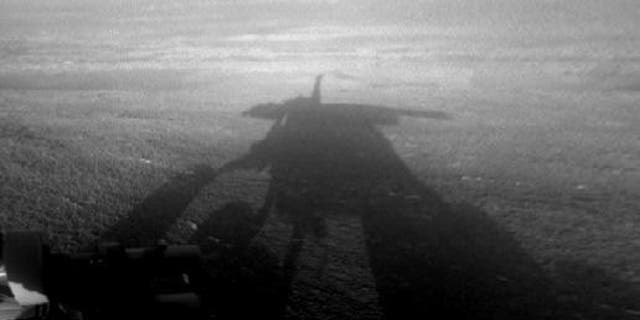 NASA's Mars Exploration Rover Opportunity captured this view of its afternoon shadow stretching into Endeavour Crater during the 3,051st Martian day, or sol, of Opportunity's work on Mars on Aug. 23, 2012.