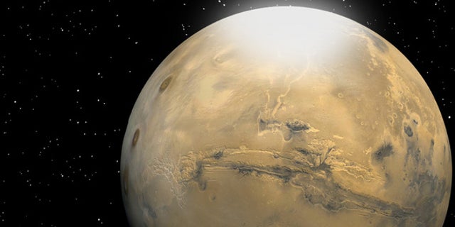 Researchers have calculated that carbon dioxide snow particles on Mars are roughly the size of a human red blood cell. Martian snow is depicted in this artist's rendering as a mist or fog that eventually settles to the surface.