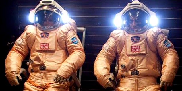 Mars500 crewmembers testing their spacesuits out before a simulated journey to the Martian surface.