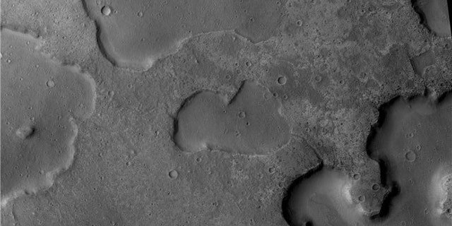 The Mars Reconnaisance Orbiter's Context Camera captured channels running between depressions, evidence of ancient drainage between lakes, researchers say. The central depression is 4 km wide.