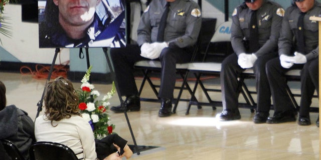 This Nov. 1, 2014 file photo shows a portrait of Santa Fe County Sheriff's Deputy Jeremy Martin during his memorial service.