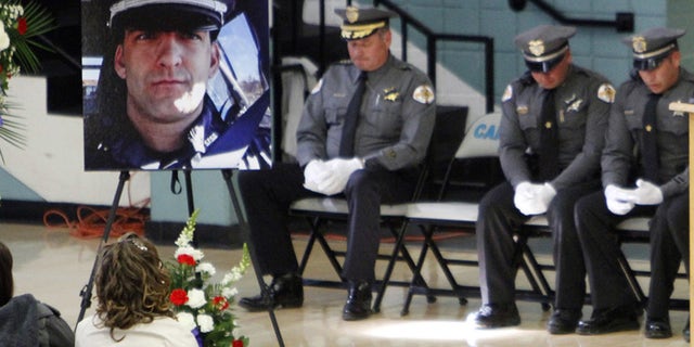 This Nov. 1, 2014 file photo shows a portrait of Santa Fe County Sheriff's Deputy Jeremy Martin during his memorial service.