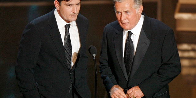 Charlie Sheen, left, and his father Martin Sheen present the best supporting actress in a miniseries or movie award during the 58th annual Primetime Emmy Awards at the Shrine Auditorium in Los Angeles August 27, 2006. REUTERS