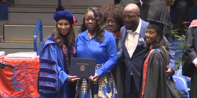 Trayvon Martin’s parents, Sybrina Fulton and Tracy Martin, take the stage at Florida Memorial University’s commencement to receive a posthumous bachelor’s degree in aeronautical science on their son’s behalf.