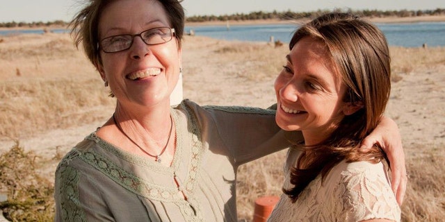 Mary Latham, 29 (right), with her mother, Pat (left), who lost her battle with breast cancer at age 61 in 2013. Latham is on a cross-country road trip gathering positive stories from strangers in honor of her mom, who always encouraged her daughter to look for the good in people and situations.