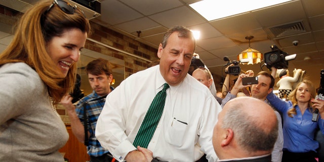 April 14, 2015: New Jersey Gov. Chris Christie, R-N.J. , accompanied by his wife Mary Pat, shakes hands with Don VanDenBerghe during a stop in New Hampshire.
