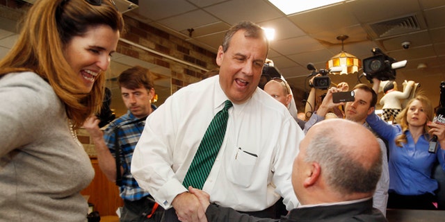 April 14, 2015: New Jersey Gov. Chris Christie, R-N.J. , accompanied by his wife Mary Pat, shakes hands with Don VanDenBerghe during a stop in New Hampshire.