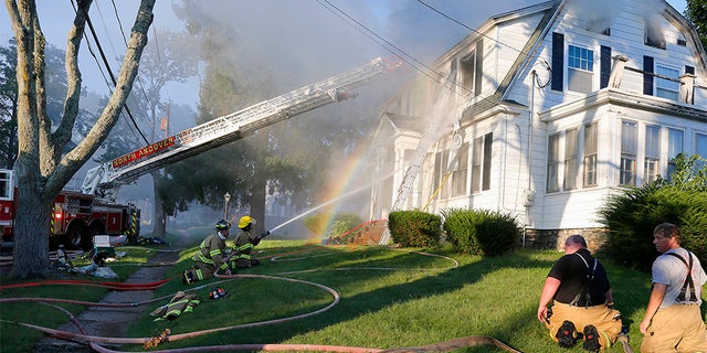 Firefighters battle a house fire in North Andover on Thursday.