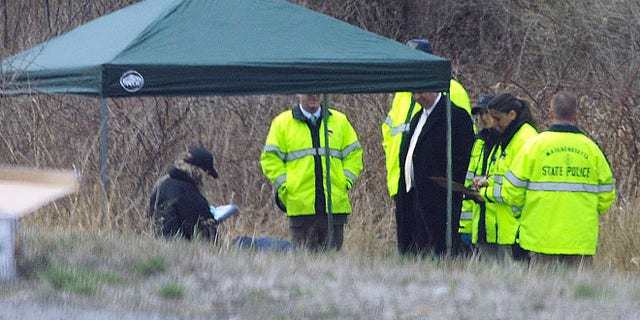 Apr. 18, 2014: Massachusetts State Police stand along Interstate 190 where police said a child's body was found near Sterling, Mass.