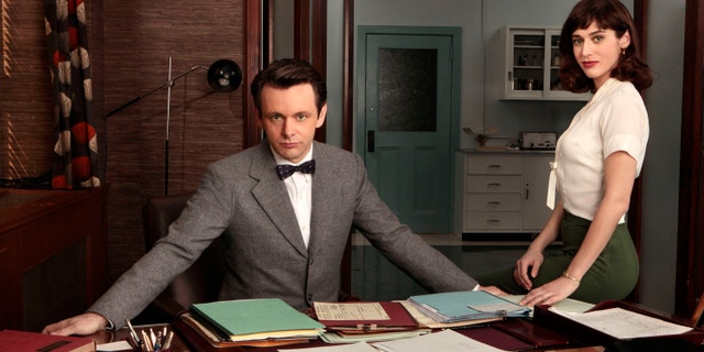This publicity image released by Showtime shows Michael Sheen as Dr. William Masters, left, and Lizzy Caplan as Virginia Johnson from "Masters of Sex."