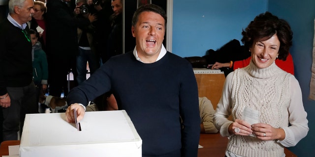 Dec. 4, 2016: Italian Premier Matteo Renzi is flanked by his wife Agnese as he casts his ballot at a polling station in Pontassieve, Italy.