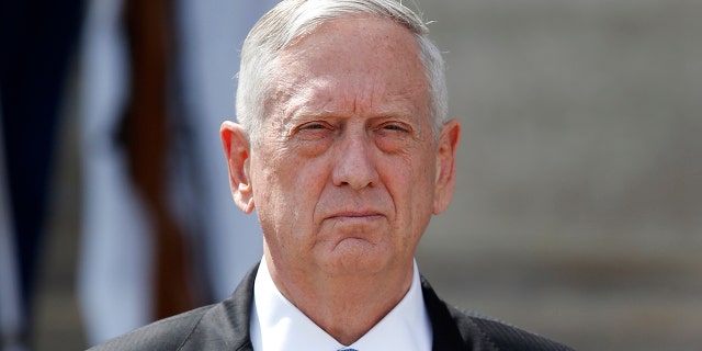 Defense Secretary Jim Mattis waits to greet Polish Defense Minister Antoni Macierewicz, upon his arrival at the Pentagon, Thursday, Sept. 21, 2017.