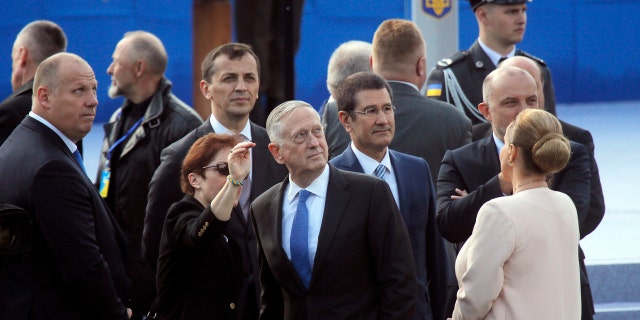 U.S. Defense Secretary Jim Mattis, center, attends a military parade to celebrate independence day in Kiev, Ukraine, Thursday, Aug. 24, 2017