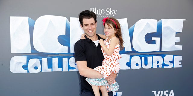Cast member Max Greenfield (L) and his daughter Lily pose at a screening of the movie "Ice Age: Collision Course" at the Fox Studios Lot in Los Angeles, California, U.S., July 16, 2016. 