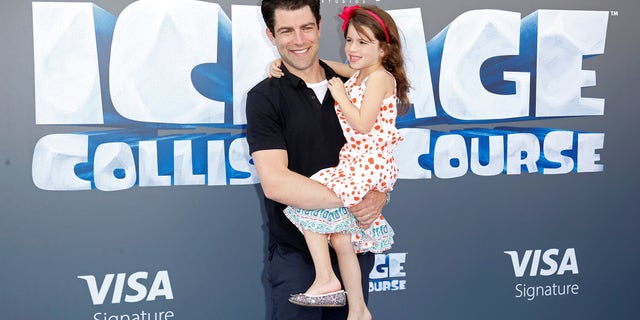 Cast member Max Greenfield (L) and his daughter Lily pose at a screening of the movie "Ice Age: Collision Course" at the Fox Studios Lot in Los Angeles, California, U.S., July 16, 2016.
