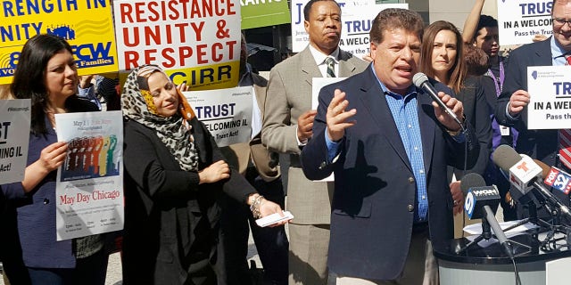 In this April 24, 2017, photo Artemio Arreola, an organizer with the Illinois Coalition for Immigrant and Refugee Rights, speaks to other advocates in downtown Chicago.