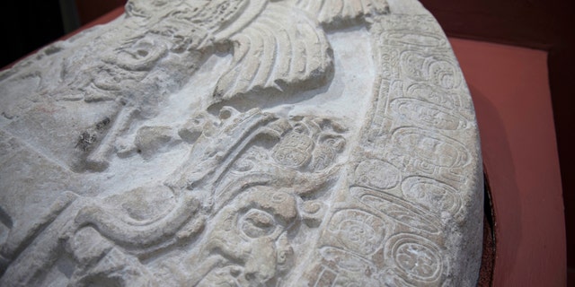 A nearly 1,500-year-old carved altar from the Maya site "La Corona," located in the northern Guatemalan department of Peten, is displayed at the National Museum of Archaeology and Ethnology in Guatemala City, Wednesday, Sept. 12, 2018. (AP Photo/Oliver de Ros)