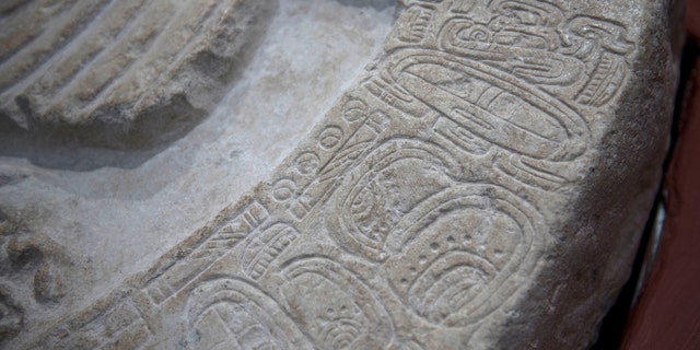 The altar is the oldest monument from the Classic Maya period found to date at the La Corona site, archaeologists say. (AP Photo/Oliver de Ros)