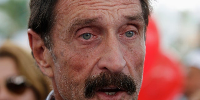 File photo. Computer software pioneer John McAfee speaks with reporters outside his hotel in Miami Beach, Florida December 13, 2012.
