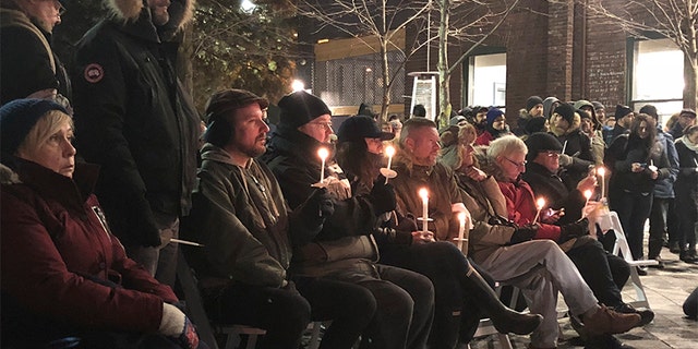 Feb. 13, 2018: People hold a candlelight vigil to remember the victims of alleged serial killer Bruce McArthur in Toronto.