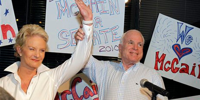 Aug. 23: Sen. John McCain with his wife Cindy McCain gets applause from supporters in Phoenix. (AP Photo)