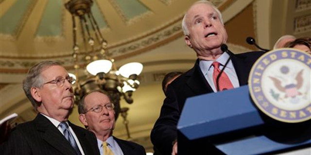 Sen. John McCain, right, speaks on Capitol Hill Dec. 1, accompanied by Senate Minority Leader Mitch McConnell, left, and Sen. Lamar Alexander. (AP Photo)