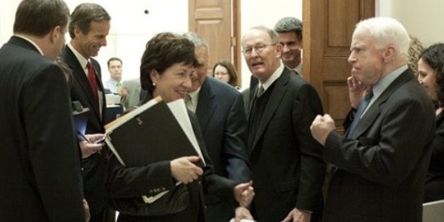 Dec. 9: Sen. John McCain plays rough with Maine Republican Sen. Susan Collins after a GOP meeting (AP).