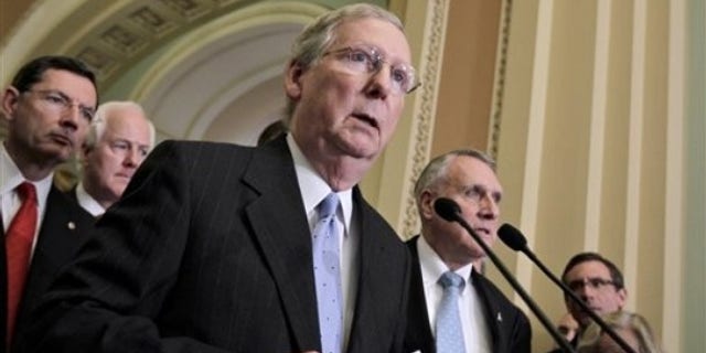 FILE: In this May 10, 2011, photo, Senate Minority Leader Mitch McConnell, R-Ky., speaks with reporters on Capitol Hill. On the far right is Minority Whip Jon Kyl of Arizona.