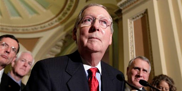 Senate Minority Leader Mitch McConnell speaks with reporters following a weekly Republican policy luncheon June 28 on Capitol Hill.