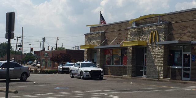 A witness said the man was holding his baby when the robbers attacked him. He then put his baby down and shot one of the suspects.