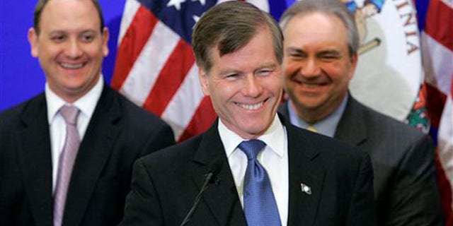 Republican Gov-elect Bob McDonnell smiles at a news conference with transition members, Phil Cox, left, and Lt. Gov. Bill Bolling, right, in Richmond Nov. 4. (AP Photo)
