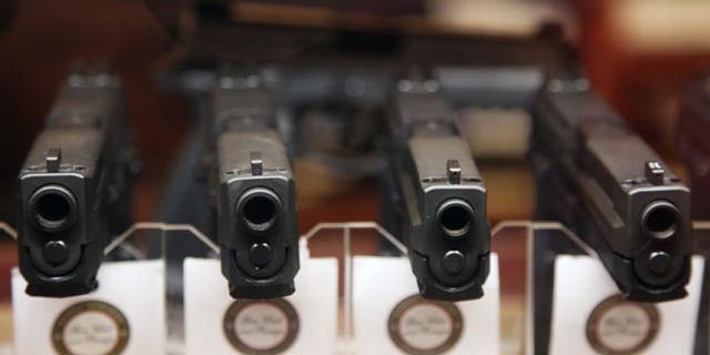 Jan. 4, 2013: Handguns are displayed in the sales area of Sandy Springs Gun Club and Range, in Sandy Springs, Ga.