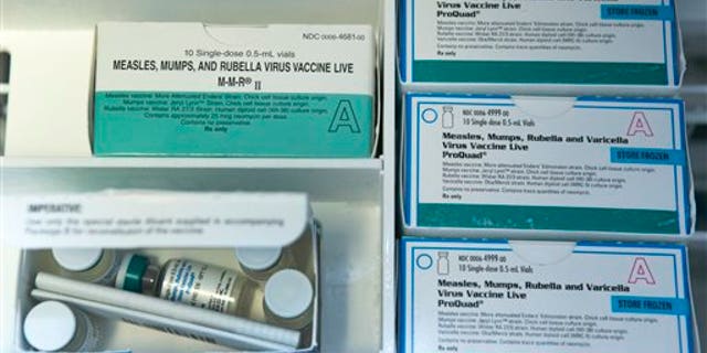 This Thursday, Jan. 29, 2015, file photo, shows boxes of the measles, mumps and rubella virus vaccine (MMR) and measles, mumps, rubella and varicella vaccine inside a freezer at a doctor's office in Northridge, Calif. (AP Photo/Damian Dovarganes, File)