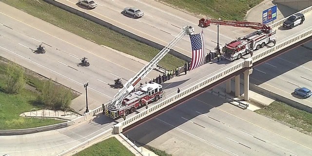 Onlookers watch the motorcade carrying Medal of Honor recipients to an event in Texas.