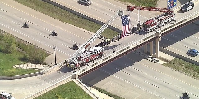 Onlookers watch the motorcade carrying Medal of Honor recipients to an event in Texas.