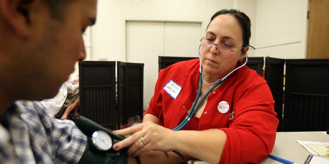 LOS ANGELES, CA - JULY 10: Nurses and physicians give free basic health screenings and call attention to what they say is the ongoing healthcare emergency despite the decision of the U.S. Supreme Court to uphold the Affordable Care Act, on July 10, 2012 in Los Angeles, California. Three days of free screenings in the Los Angeles area are part of the Medicare for All tour which is making up to two dozen stops across California between June 19 and July 12. The California Nurses Association says that 30 percent of Los Angeles County adults are uninsured and 18 percent cannot afford doctor visits. (Photo by David McNew/Getty Images)
